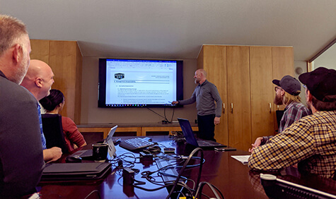 Employees attend a meeting.