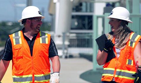 Two workers wearing safety vests.